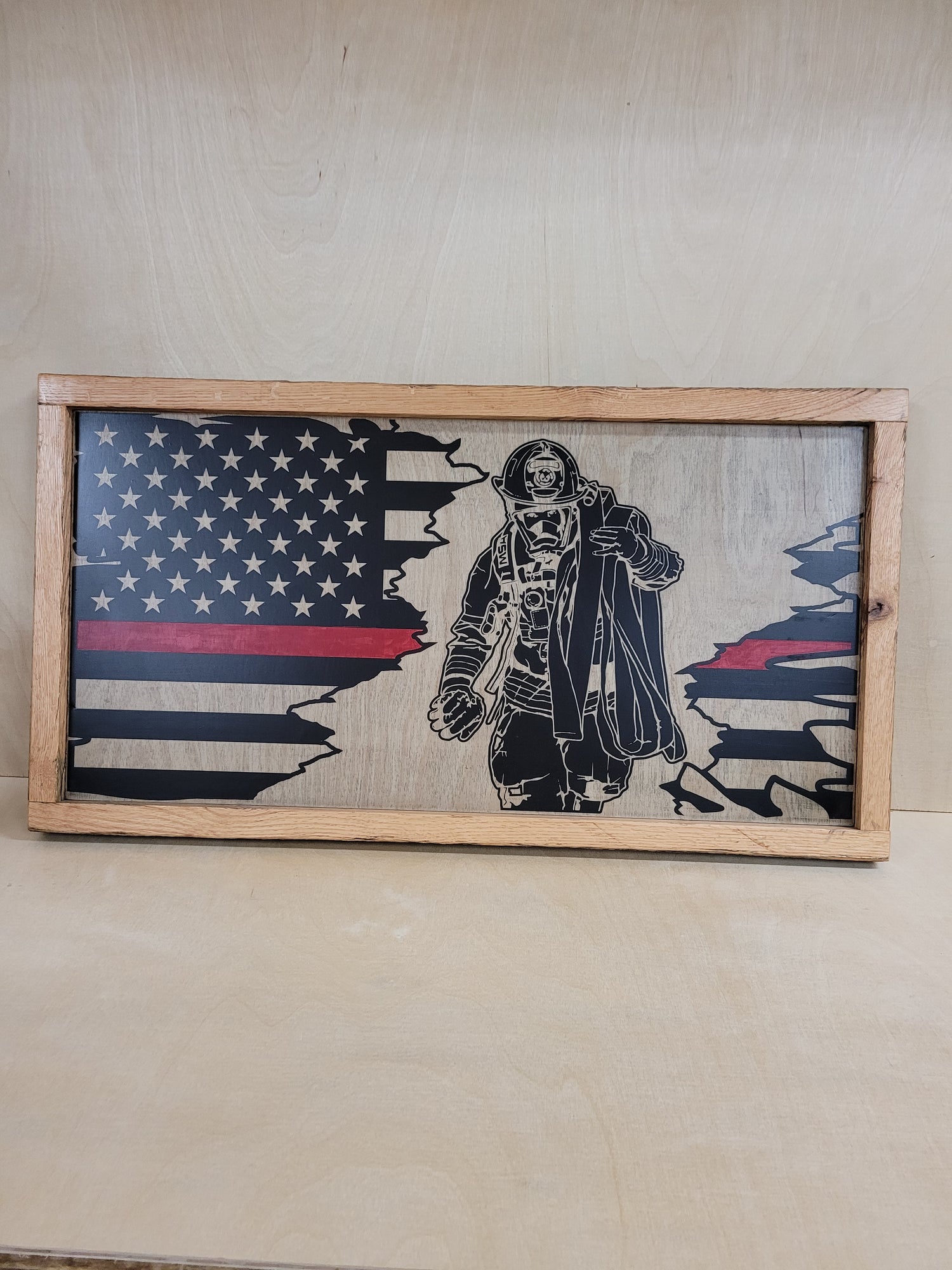 Thin red line flag with firefighter tear-out section. Framed with old oak fence boards.